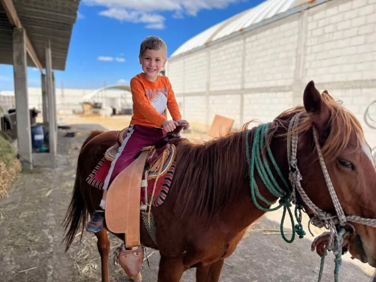 Caleb riding a horse at the pastor's house
