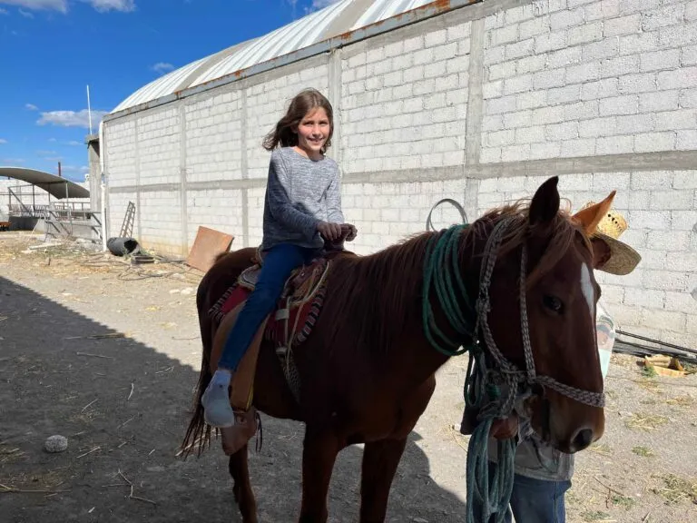 Elizabeth riding a horse at the pastor's house