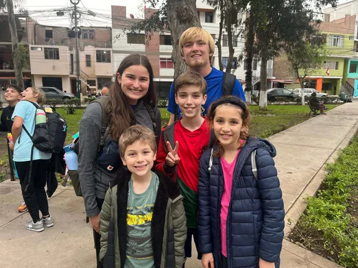 The kids with a team visiting from the US