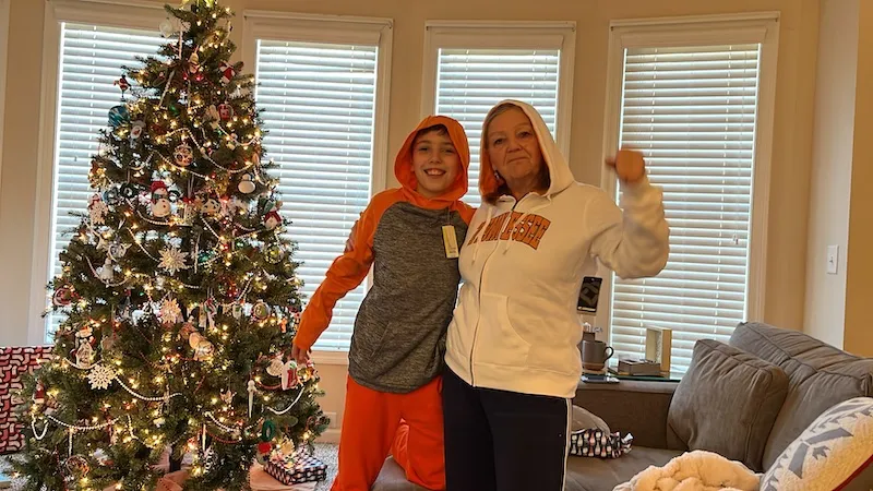 Grammy and Joshua in front of the Christmas tree